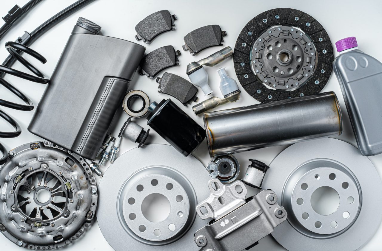 new metal auto parts on grey background - Royal Tuning autó és motoros kiegészítő webshop